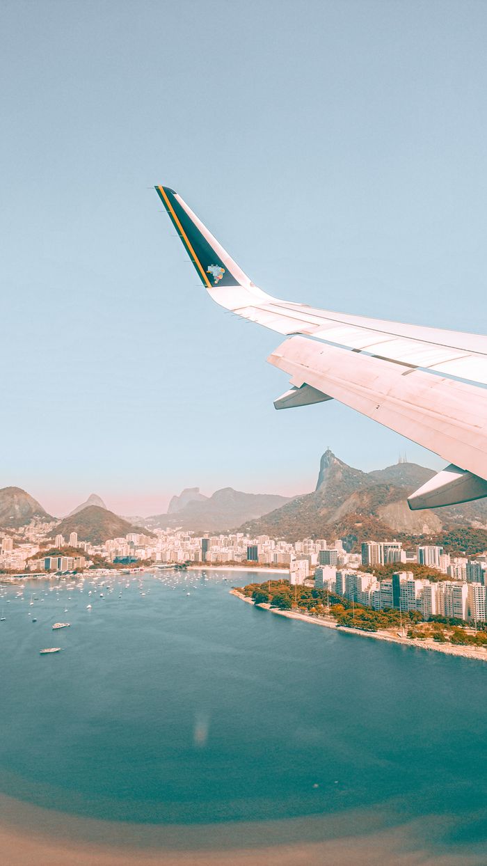 Scenic aerial view of Rio de Janeiro with Sugarloaf Mountain from an airplane window.